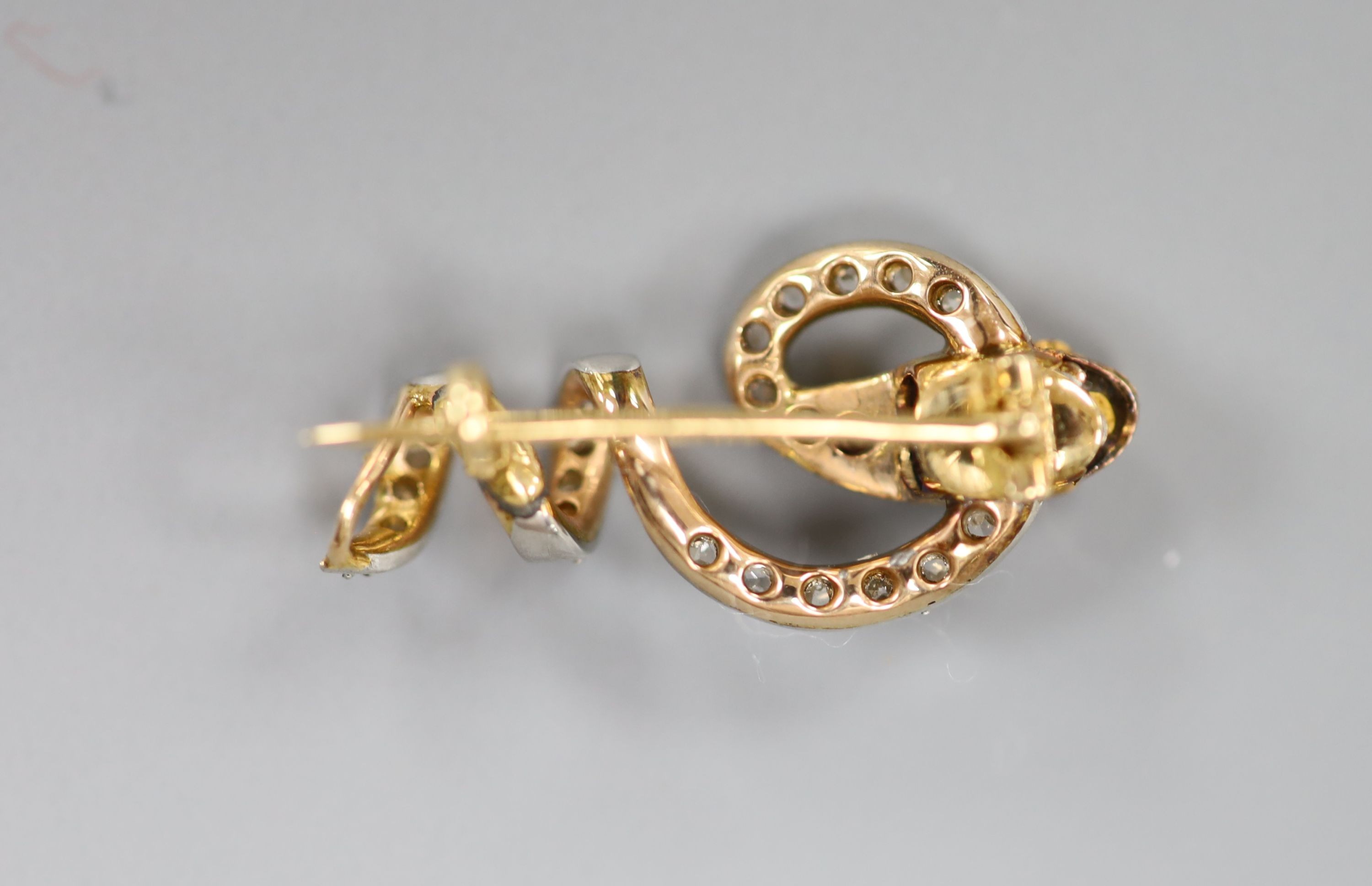 A Victorian yellow metal, emerald, ruby and rose cut diamond set serpent brooch, 25mm, gross weight 3.5 grams